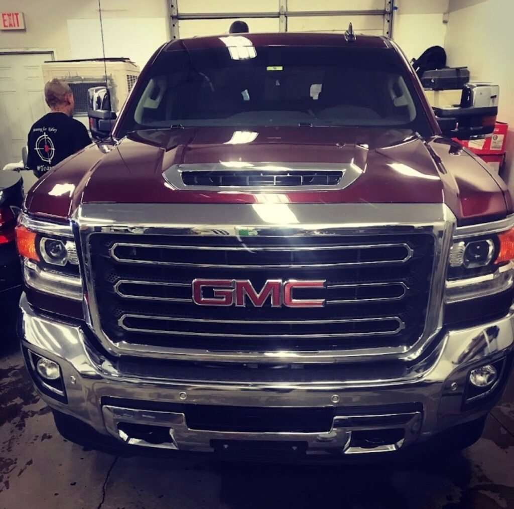 Maroon GMC Sierra finished after collision repair and paint at Extreme Twist Collision auto body shop in Santa Fe, New Mexico